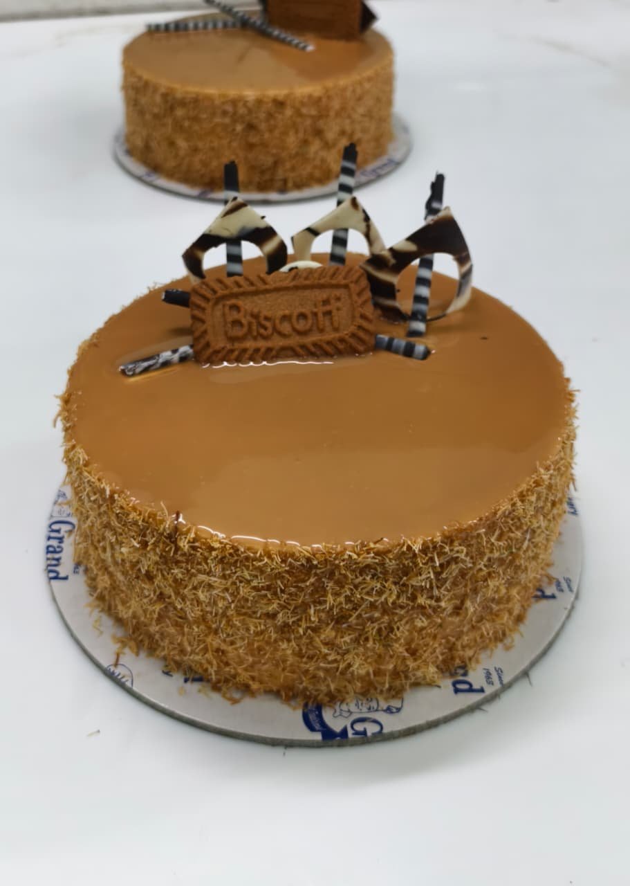 A Grand Bakery signature cake, handcrafted and finished with a real Biscoff biscuit